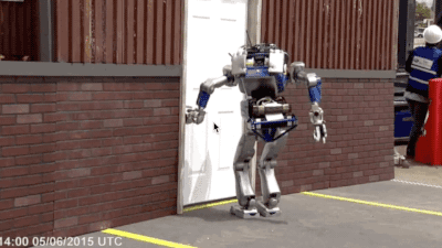 A robot trying to open a door and falling down