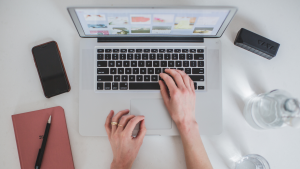 Person typing on a mac laptop