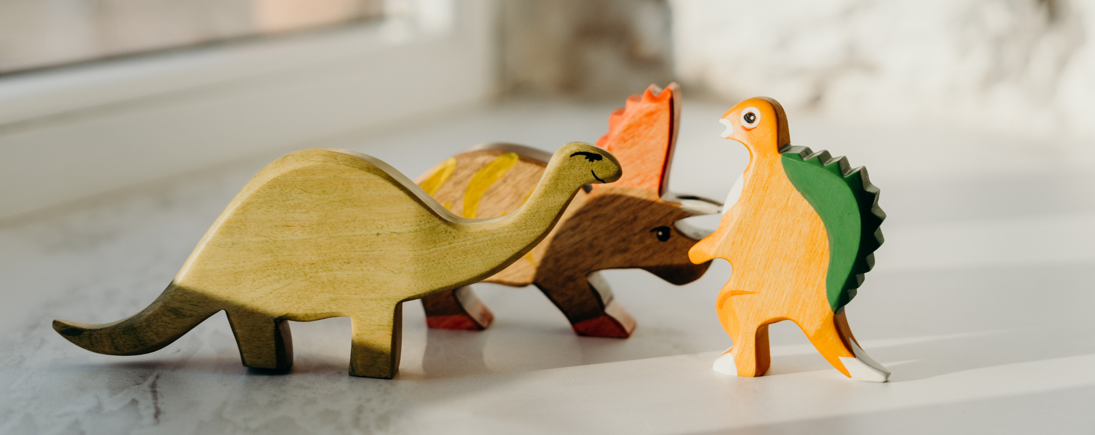 Picture of 3 wooden toy dinosaurs