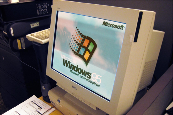 a picture of a old computer with the windows 95 starting screen