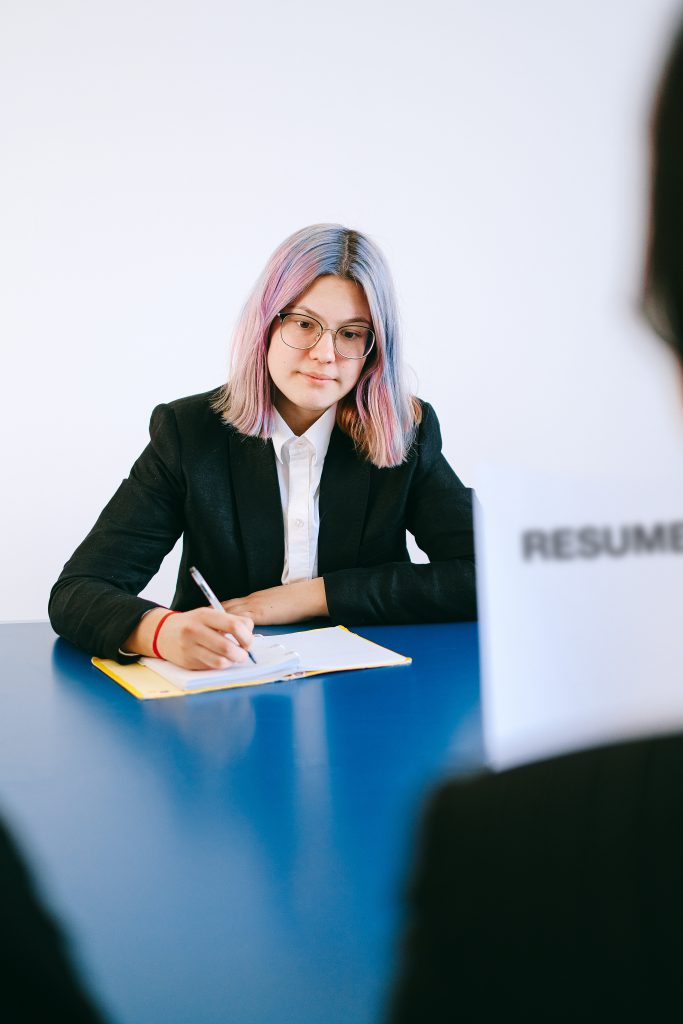 Job interviewee taking notes during an interview and looking concentrated