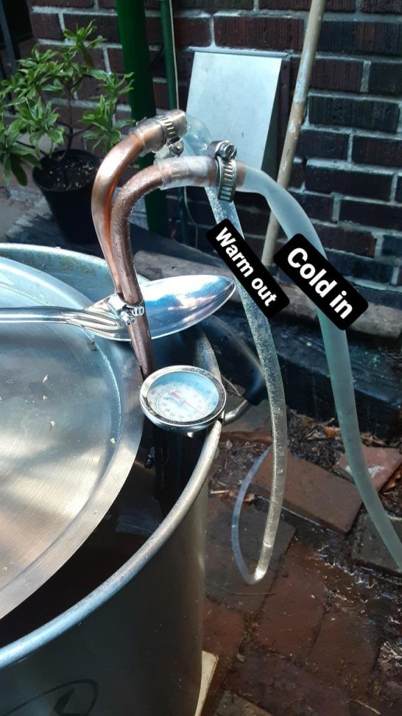 Picture of the cold water coming into the copper coil for cooling. The cold water has condensation on the tube, the water coming out looks all bubbly. Text: Warm out. Cold in.