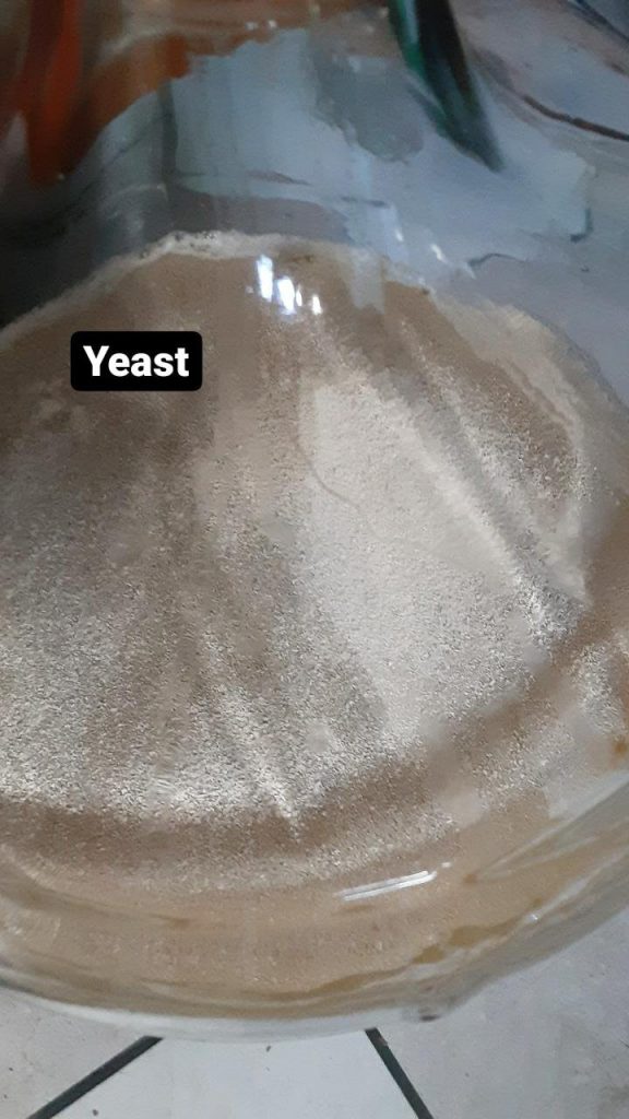 Picture of dry yeast floating on the liquid surface.